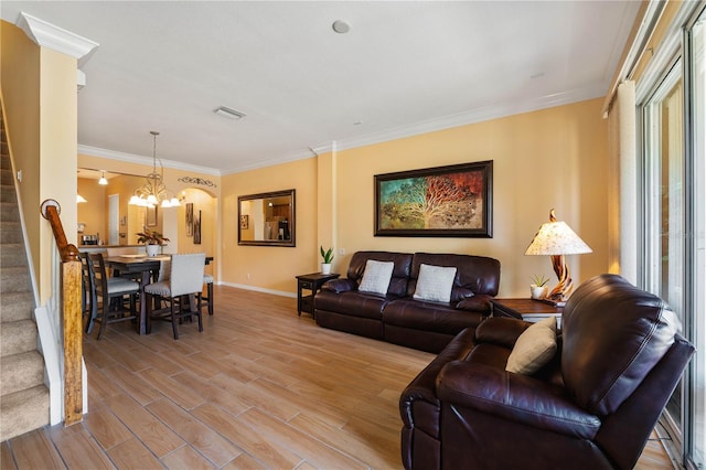 6677 84th Ave N, Pinellas Park, FL 33781 - living area featuring stairs, a chandelier, wood finished floors, and crown molding