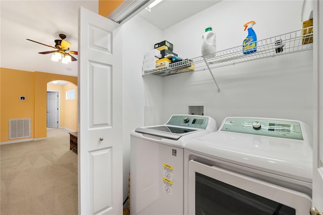 6677 84th Ave N, Pinellas Park, FL 33781 - laundry area featuring washing machine and clothes dryer, arched walkways, light carpet, and ceiling fan
