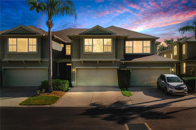 6677 84th Ave N, Pinellas Park, FL 33781 - townhome / multi-family property with stucco siding, a garage, and driveway