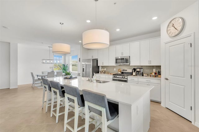 43250 Water Bird Way Unit 5921, Punta Gorda, FL 33982 - kitchen featuring appliances with stainless steel finishes, light tile patterned floors, white cabinets, a spacious island, and recessed lighting