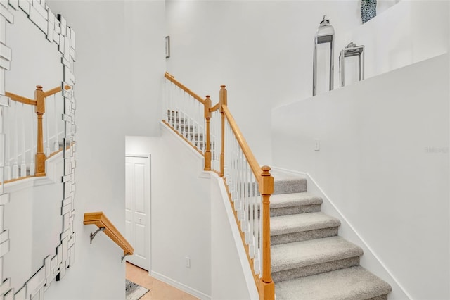 43250 Water Bird Way Unit 5921, Punta Gorda, FL 33982 - staircase with a towering ceiling and baseboards