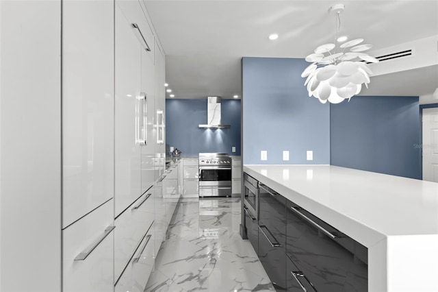 5153 Isla Key Blvd S Unit 415, Saint Petersburg, FL 33715 - kitchen with modern cabinets, appliances with stainless steel finishes, wall chimney exhaust hood, a chandelier, and recessed lighting