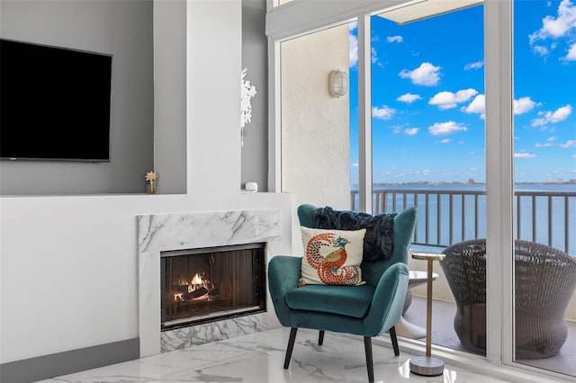 5153 Isla Key Blvd S Unit 415, Saint Petersburg, FL 33715 - living area featuring a premium fireplace, plenty of natural light, marble finish floors, and a water view