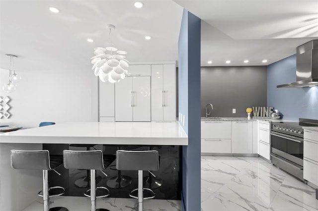 5153 Isla Key Blvd S Unit 415, Saint Petersburg, FL 33715 - kitchen with wall chimney range hood, stainless steel stove, modern cabinets, recessed lighting, and a breakfast bar