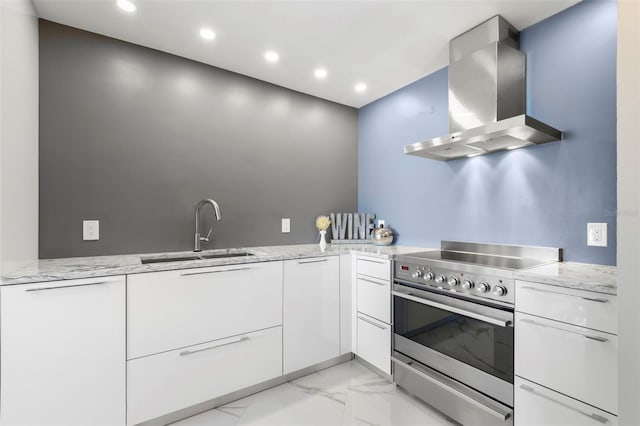 5153 Isla Key Blvd S Unit 415, Saint Petersburg, FL 33715 - kitchen featuring wall chimney exhaust hood, high end range, light marble finish floors, light stone countertops, and recessed lighting