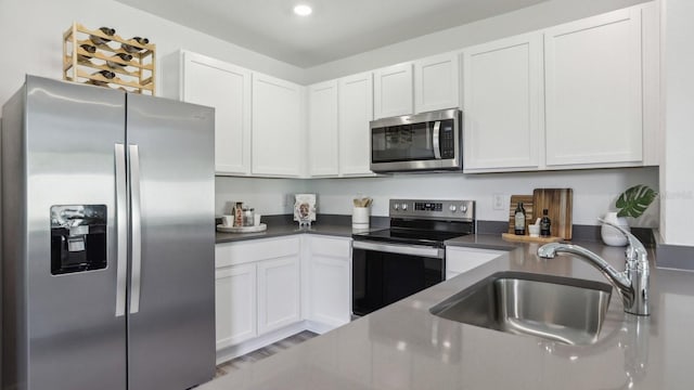 4319 Sand Dollar Way, Zephyrhills, FL 33541 - kitchen with stainless steel appliances, dark countertops, white cabinets, and recessed lighting