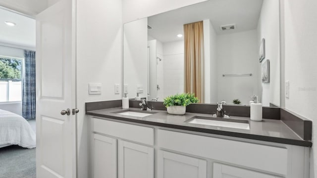 4319 Sand Dollar Way, Zephyrhills, FL 33541 - ensuite bathroom with double vanity, recessed lighting, and a shower with curtain