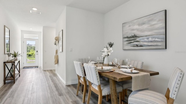 4302 Sand Dollar Way, Zephyrhills, FL 33541 - dining area featuring light wood-style floors and baseboards