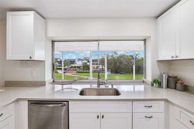 6521 Bimini Ct, Apollo Beach, FL 33572 - kitchen featuring stainless steel dishwasher, light countertops, and white cabinets