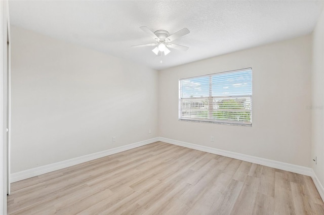 6521 Bimini Ct, Apollo Beach, FL 33572 - spare room featuring light wood-style floors, ceiling fan, and a textured ceiling