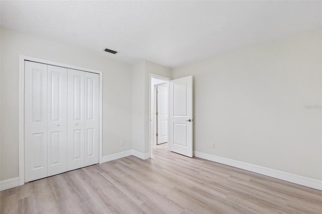 6521 Bimini Ct, Apollo Beach, FL 33572 - unfurnished bedroom with light wood-type flooring and a closet