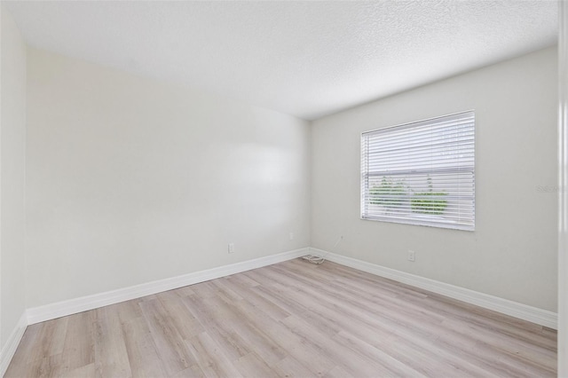 6521 Bimini Ct, Apollo Beach, FL 33572 - spare room with light wood-style floors and a textured ceiling