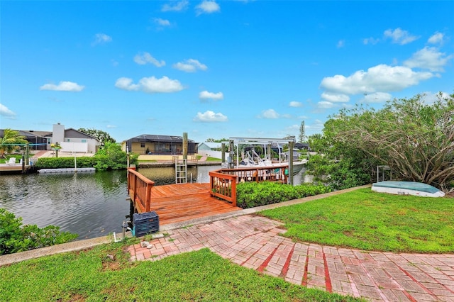 6521 Bimini Ct, Apollo Beach, FL 33572 - dock area with a water view, boat lift, a lawn, and a residential view
