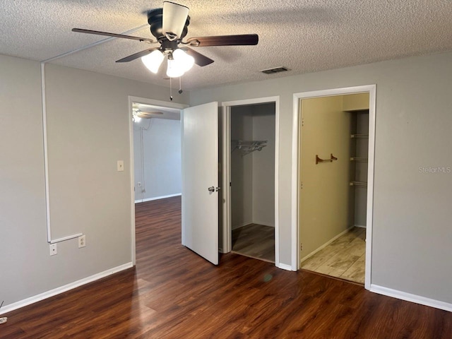 101 Lake Ave NE Unit 121, Largo, FL 33771 - unfurnished bedroom with wood finished floors, a textured ceiling, a closet, and ceiling fan