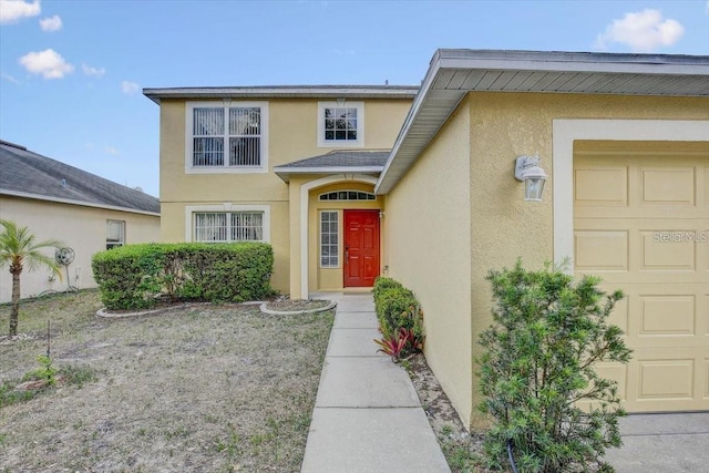 10437 River Bream Dr, Riverview, FL 33569 - view of exterior entry with a garage and stucco siding