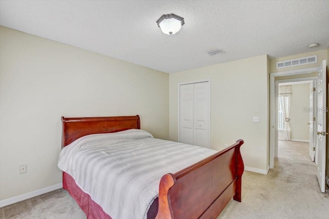 10437 River Bream Dr, Riverview, FL 33569 - bedroom with light carpet, a closet, and a textured ceiling