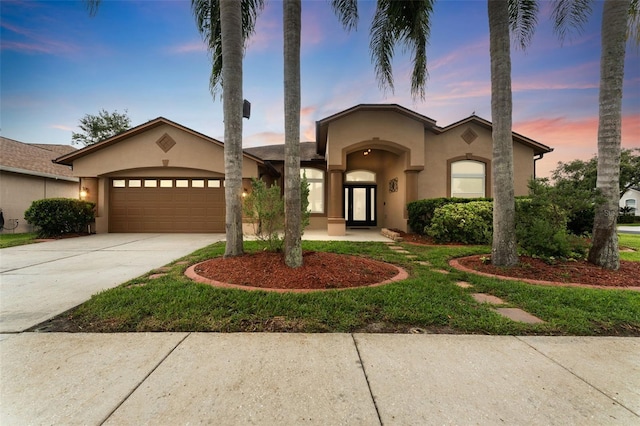 25946 Buckthorn Ave, Land O Lakes, FL 34639 - view of front facade with stucco siding, driveway, and an attached garage