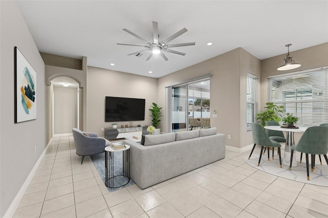 25946 Buckthorn Ave, Land O Lakes, FL 34639 - living room featuring arched walkways, a ceiling fan, light tile patterned floors, and recessed lighting