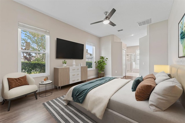 25946 Buckthorn Ave, Land O Lakes, FL 34639 - bedroom featuring light wood finished floors, connected bathroom, and a ceiling fan