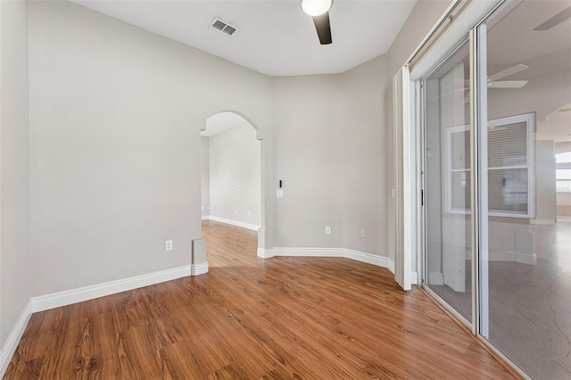 25946 Buckthorn Ave, Land O Lakes, FL 34639 - unfurnished room with a ceiling fan, arched walkways, and wood finished floors