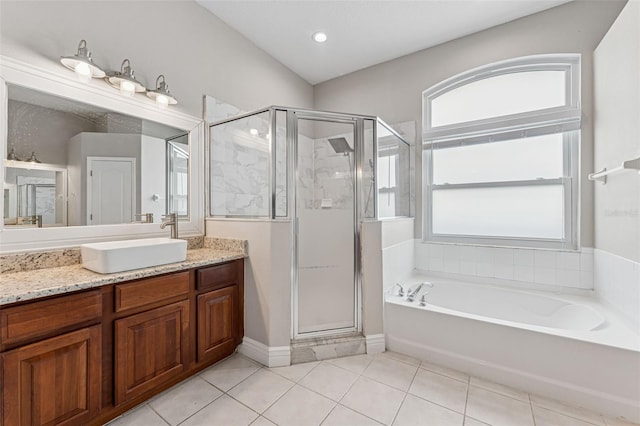 25946 Buckthorn Ave, Land O Lakes, FL 34639 - bathroom featuring vanity, a bath, tile patterned floors, and a stall shower