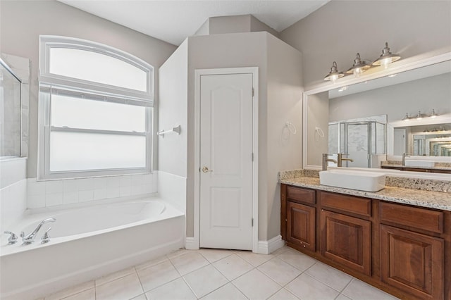 25946 Buckthorn Ave, Land O Lakes, FL 34639 - full bathroom with a bath, vanity, tile patterned floors, and a stall shower
