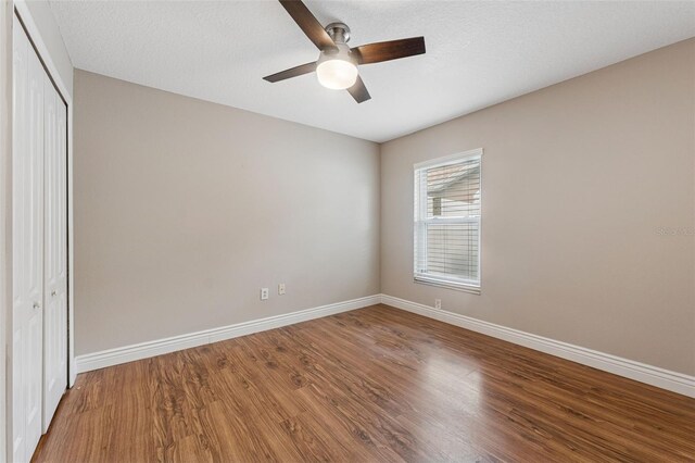 25946 Buckthorn Ave, Land O Lakes, FL 34639 - unfurnished bedroom featuring a closet, wood finished floors, and ceiling fan