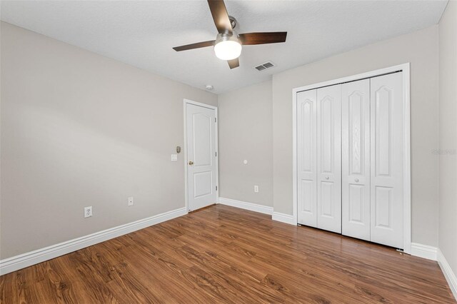 25946 Buckthorn Ave, Land O Lakes, FL 34639 - unfurnished bedroom featuring wood finished floors, a closet, and ceiling fan