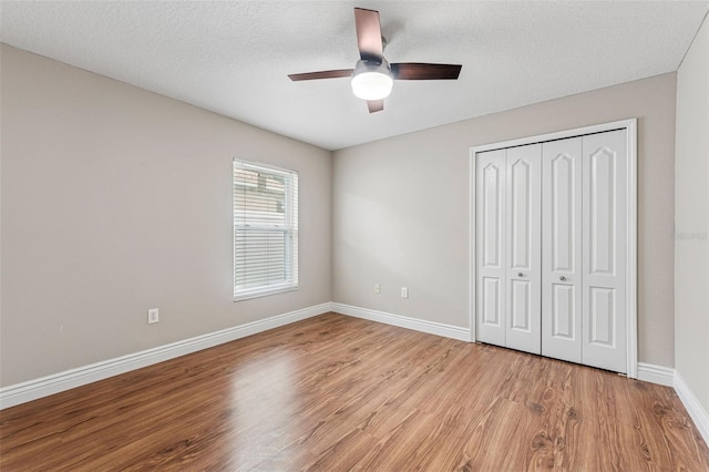 25946 Buckthorn Ave, Land O Lakes, FL 34639 - unfurnished bedroom featuring wood finished floors, a closet, and ceiling fan