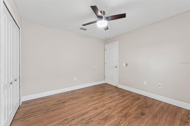 25946 Buckthorn Ave, Land O Lakes, FL 34639 - unfurnished bedroom featuring wood finished floors, a closet, and a ceiling fan