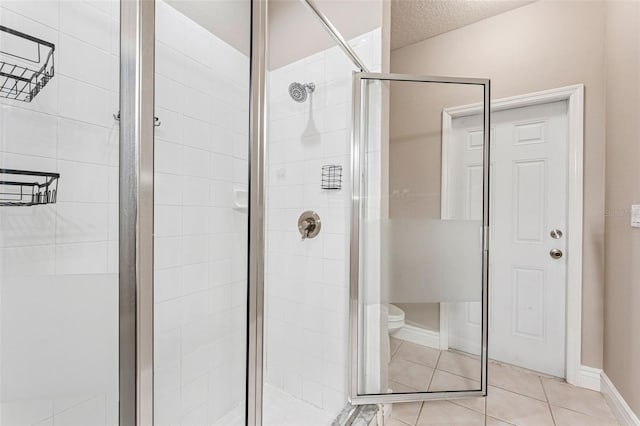 25946 Buckthorn Ave, Land O Lakes, FL 34639 - bathroom with a stall shower, tile patterned floors, and a textured ceiling