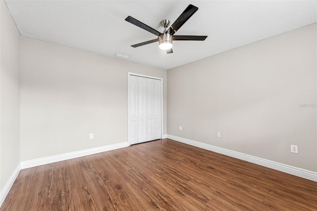 25946 Buckthorn Ave, Land O Lakes, FL 34639 - unfurnished bedroom with wood finished floors, a closet, and a ceiling fan