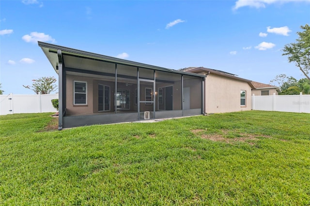 25946 Buckthorn Ave, Land O Lakes, FL 34639 - back of property featuring a sunroom, a fenced backyard, and stucco siding