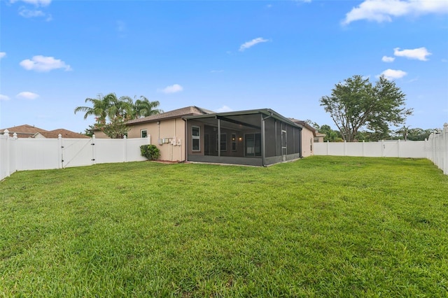 25946 Buckthorn Ave, Land O Lakes, FL 34639 - rear view of property with a sunroom, a fenced backyard, and a gate