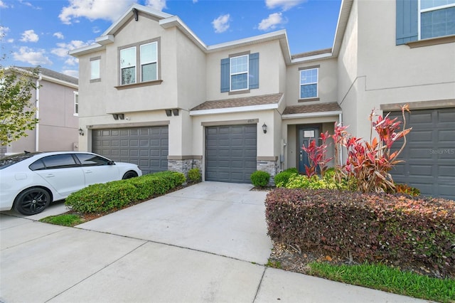 6825 Citrus Creek Ln, Tampa, FL 33625 - multi unit property with a garage, stucco siding, stone siding, and concrete driveway