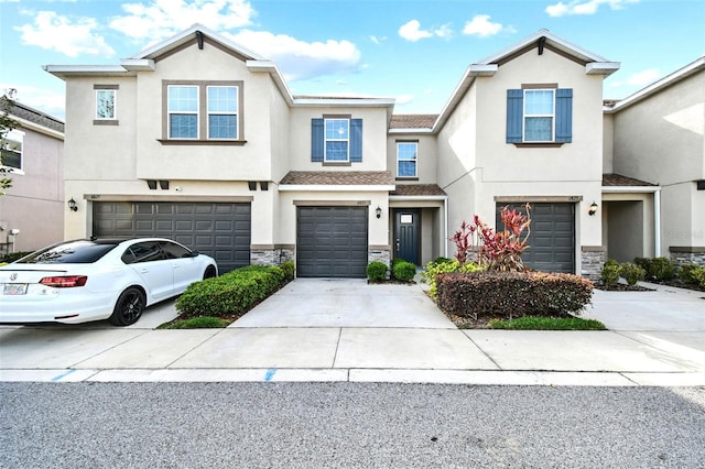 6825 Citrus Creek Ln, Tampa, FL 33625 - multi unit property with a garage, stone siding, stucco siding, and concrete driveway