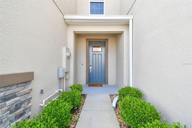6825 Citrus Creek Ln, Tampa, FL 33625 - view of exterior entry featuring stucco siding