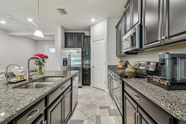 6825 Citrus Creek Ln, Tampa, FL 33625 - kitchen with stainless steel appliances, stone counters, light tile patterned floors, decorative light fixtures, and recessed lighting