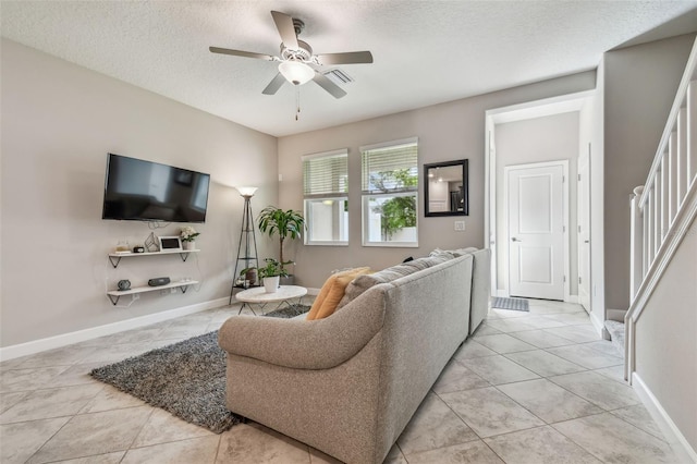6825 Citrus Creek Ln, Tampa, FL 33625 - living room with a ceiling fan, a textured ceiling, light tile patterned floors, and stairs