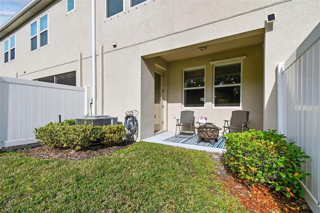 6825 Citrus Creek Ln, Tampa, FL 33625 - view of exterior entry featuring stucco siding and a patio area