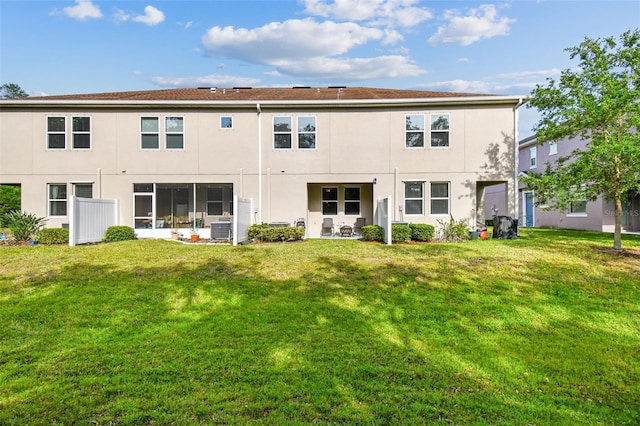 6825 Citrus Creek Ln, Tampa, FL 33625 - rear view of property featuring stucco siding and a lawn