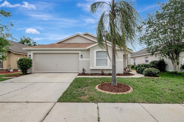 4129 Marlow Loop, Land O Lakes, FL 34639 - ranch-style home featuring a garage, driveway, a front yard, brick siding, and stucco siding