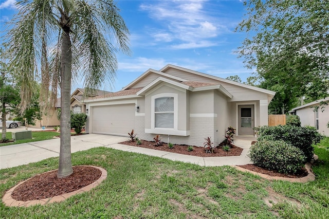 4129 Marlow Loop, Land O Lakes, FL 34639 - ranch-style house with driveway, an attached garage, brick siding, and a front lawn