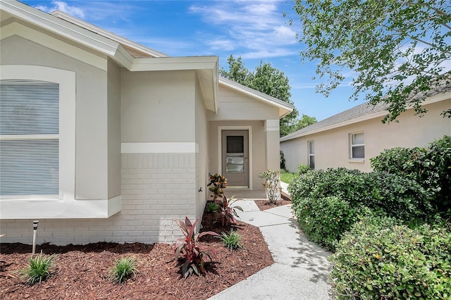 4129 Marlow Loop, Land O Lakes, FL 34639 - doorway to property featuring stucco siding and brick siding