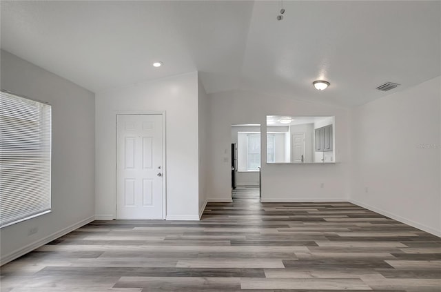 4129 Marlow Loop, Land O Lakes, FL 34639 - empty room with lofted ceiling and wood finished floors