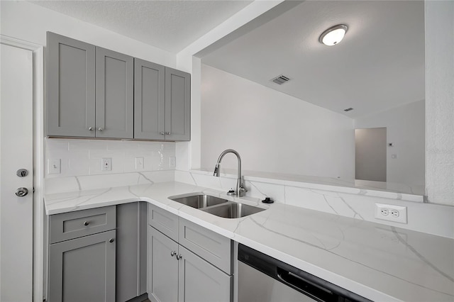 4129 Marlow Loop, Land O Lakes, FL 34639 - kitchen featuring gray cabinetry, light stone countertops, and decorative backsplash