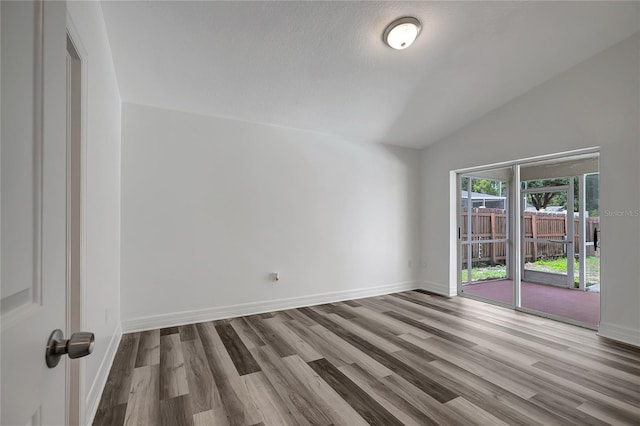 4129 Marlow Loop, Land O Lakes, FL 34639 - spare room featuring lofted ceiling and wood finished floors