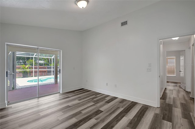 4129 Marlow Loop, Land O Lakes, FL 34639 - unfurnished room featuring wood finished floors and a sunroom