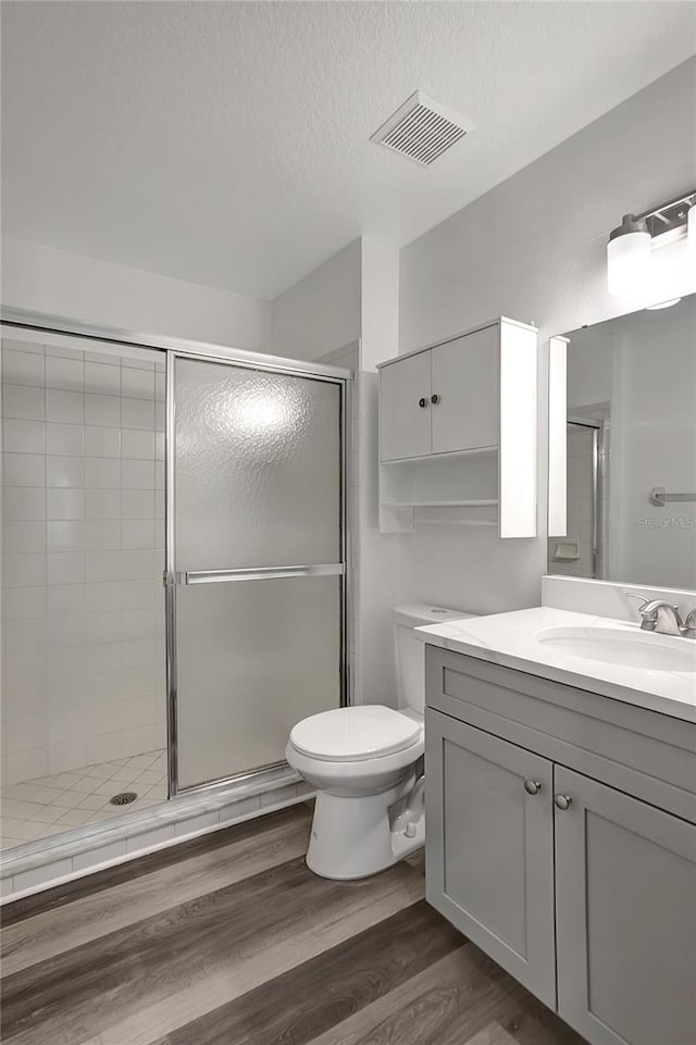 4129 Marlow Loop, Land O Lakes, FL 34639 - full bath with vanity, a stall shower, wood finished floors, and a textured ceiling