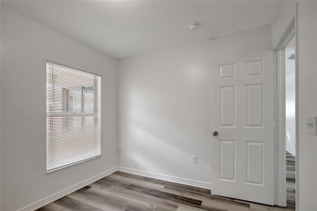 4129 Marlow Loop, Land O Lakes, FL 34639 - spare room with wood finished floors and a smoke detector